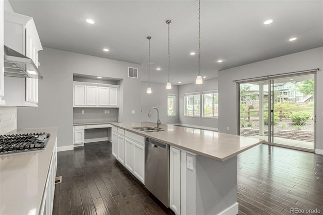 17490 W 94th Dr, Arvada, CO 80007 - kitchen with stainless steel appliances, wall chimney exhaust hood, dark wood finished floors, light countertops, and recessed lighting