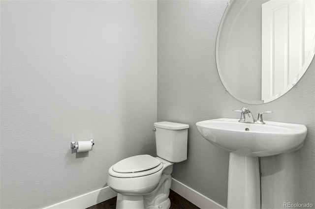 17490 W 94th Dr, Arvada, CO 80007 - bathroom featuring baseboards and wood finished floors