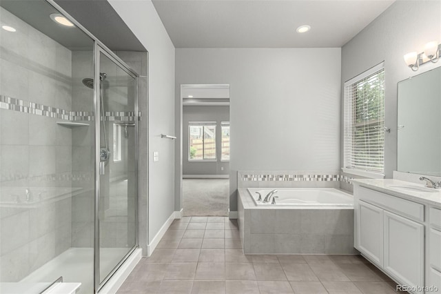 17490 W 94th Dr, Arvada, CO 80007 - full bath with healthy amount of natural light, vanity, tile patterned flooring, a garden tub, and recessed lighting