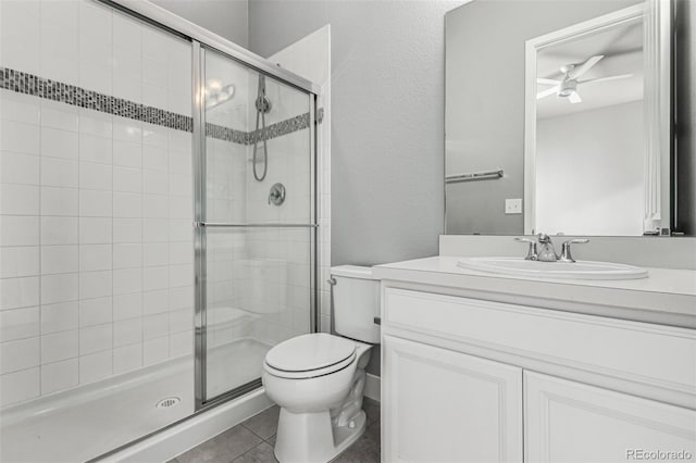 17490 W 94th Dr, Arvada, CO 80007 - full bathroom with a stall shower, vanity, a ceiling fan, and tile patterned flooring