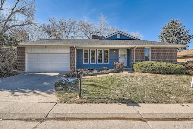 single story home featuring a garage and a front yard