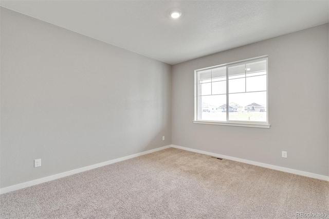 unfurnished room featuring carpet flooring