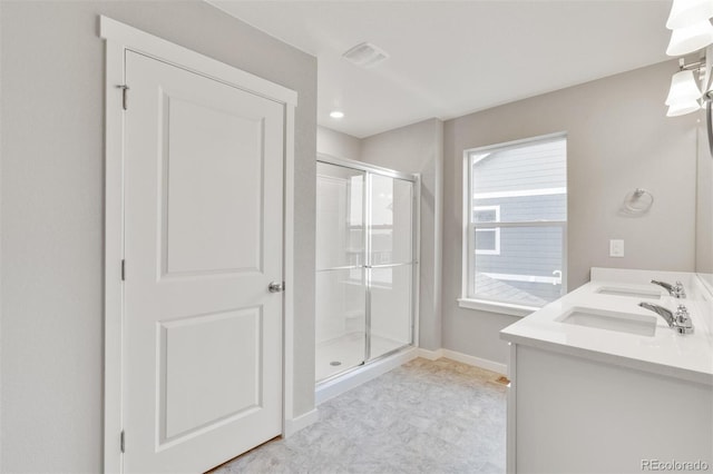 bathroom featuring vanity and a shower with shower door