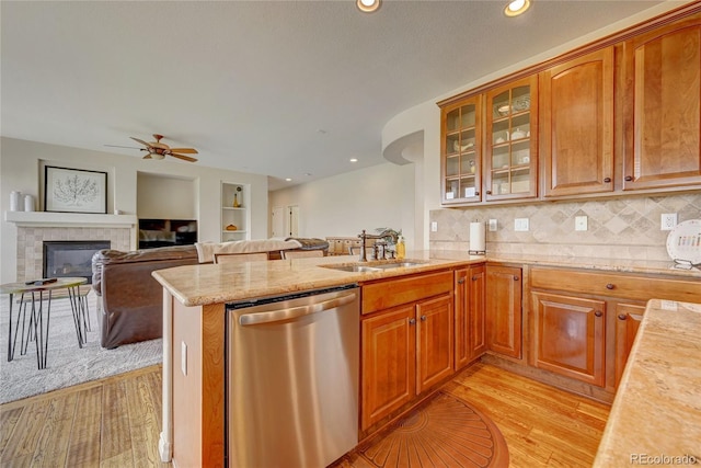 4864 Harness Ct, Parker, CO 80134 - kitchen with dishwasher, a sink, light wood-type flooring, a peninsula, and a ceiling fan
