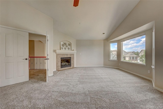4864 Harness Ct, Parker, CO 80134 - unfurnished living room with carpet flooring, vaulted ceiling, a fireplace, and baseboards