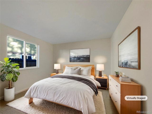 bedroom featuring baseboards and light carpet