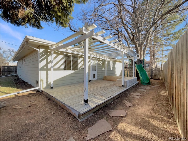 wooden terrace with a fenced backyard and a pergola