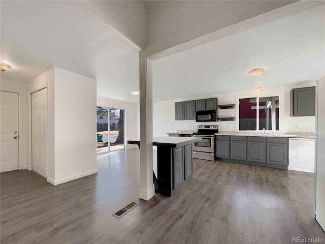 kitchen featuring visible vents, gray cabinetry, black microwave, stainless steel electric range, and white dishwasher