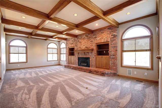 unfurnished living room featuring beamed ceiling, a fireplace, coffered ceiling, and carpet flooring