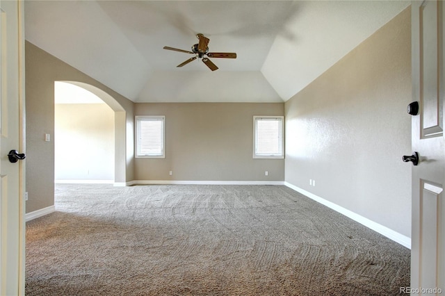 carpeted spare room featuring ceiling fan, plenty of natural light, and vaulted ceiling