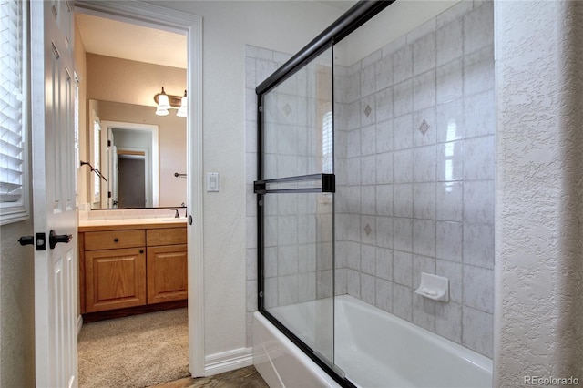 bathroom featuring vanity and shower / bath combination with glass door