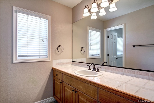 bathroom with vanity and a healthy amount of sunlight