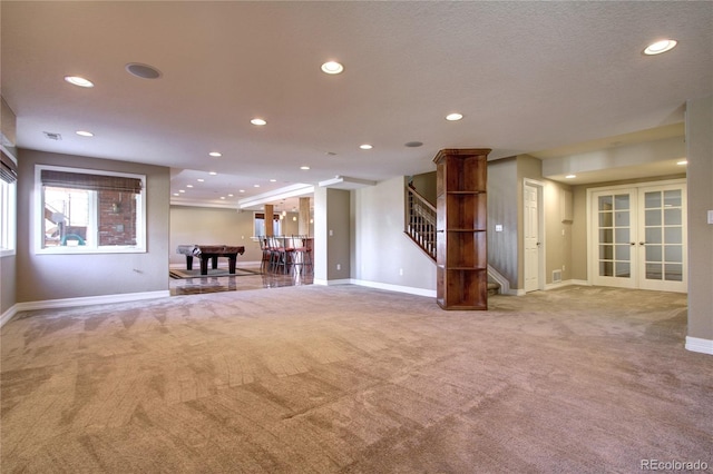 unfurnished living room with light carpet and french doors