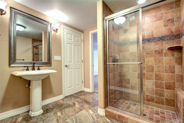 bathroom with an enclosed shower and a textured ceiling