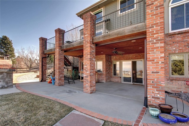 view of patio featuring ceiling fan and a balcony