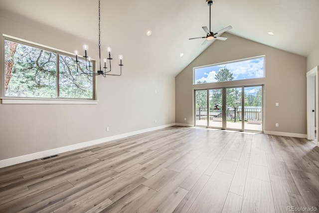 211 E Pikes Peak Ave, Woodland Park, CO 80863 - unfurnished living room featuring high vaulted ceiling, a ceiling fan, a chandelier, wood finished floors, and recessed lighting