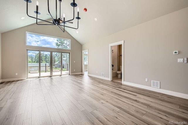 211 E Pikes Peak Ave, Woodland Park, CO 80863 - unfurnished living room with a chandelier, high vaulted ceiling, light wood finished floors, and recessed lighting