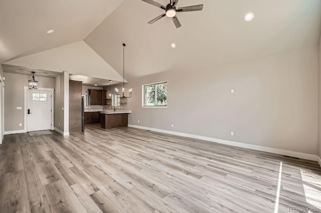 211 E Pikes Peak Ave, Woodland Park, CO 80863 - unfurnished living room featuring ceiling fan, plenty of natural light, light wood-style flooring, high vaulted ceiling, and recessed lighting