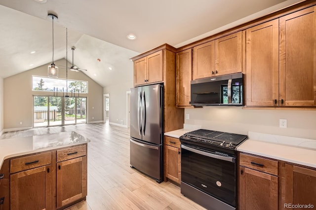 211 E Pikes Peak Ave, Woodland Park, CO 80863 - kitchen with gas range, freestanding refrigerator, brown cabinets, light wood finished floors, and ceiling fan