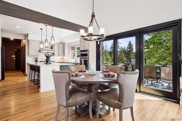 1570 Blakcomb Ct, Evergreen, CO 80439 - dining space featuring a chandelier, light wood finished floors, and plenty of natural light