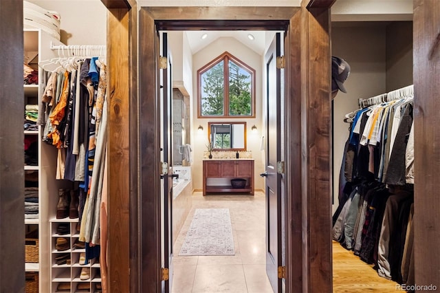 1570 Blakcomb Ct, Evergreen, CO 80439 - walk in closet featuring lofted ceiling and light tile patterned flooring
