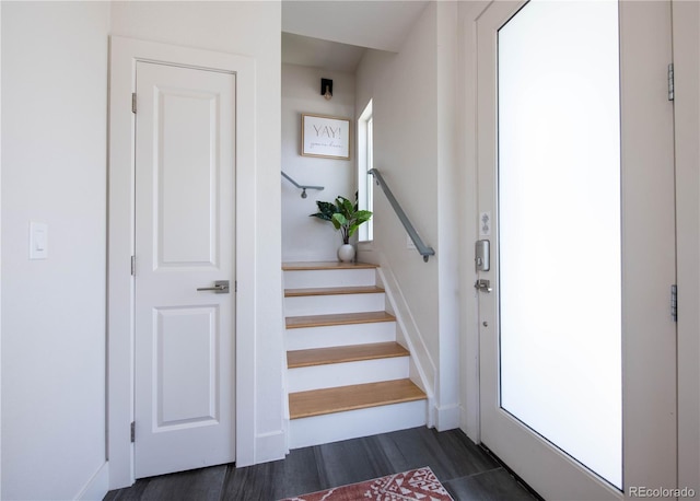 stairway featuring baseboards and wood finished floors
