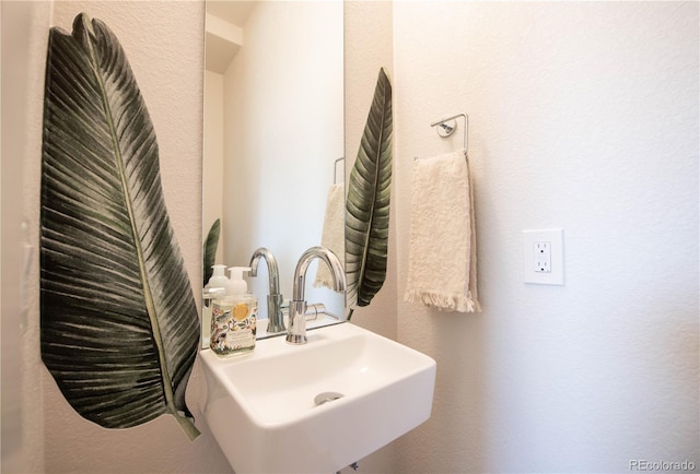 bathroom with a sink and a textured wall