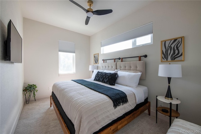 carpeted bedroom with ceiling fan and baseboards