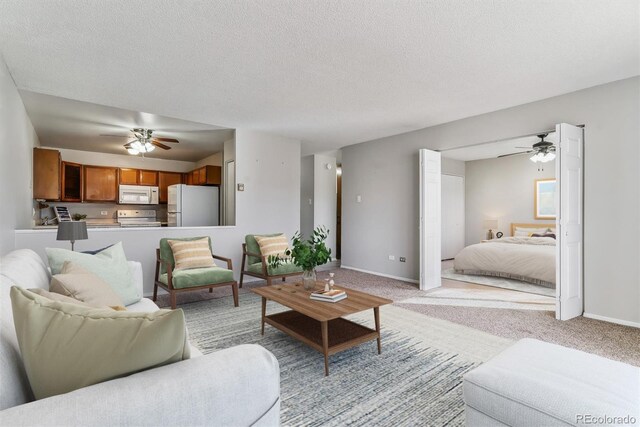 9155 E Center Ave Unit 3C, Denver, CO 80247 - living area featuring a ceiling fan, light carpet, and a textured ceiling