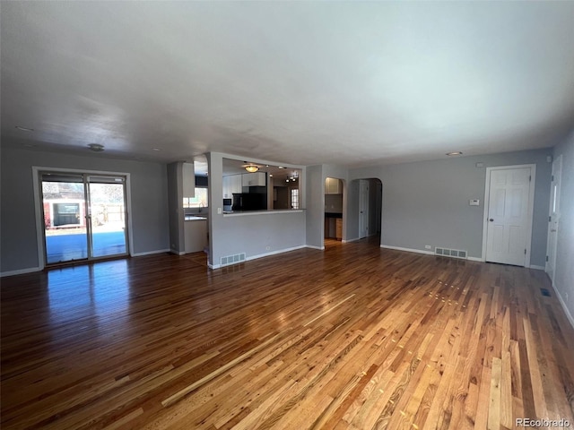 unfurnished living room with wood-type flooring