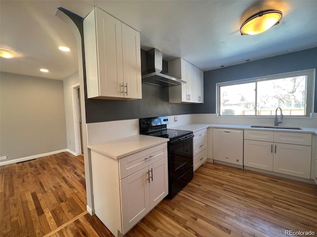 kitchen featuring white dishwasher, white cabinets, sink, wall chimney exhaust hood, and black range with electric cooktop