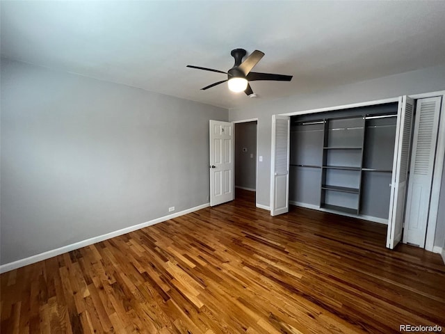 unfurnished bedroom with ceiling fan and dark wood-type flooring