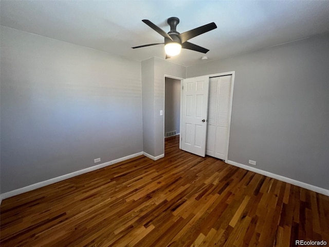 unfurnished bedroom featuring ceiling fan, dark hardwood / wood-style floors, and a closet