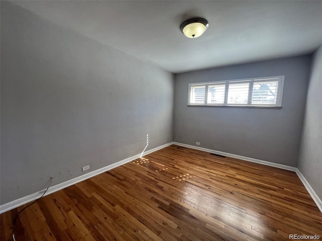 spare room with hardwood / wood-style flooring