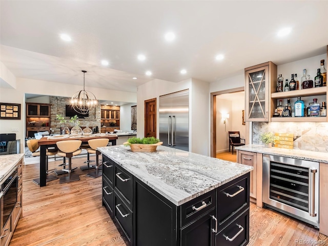 62 N Ranch Rd, Littleton, CO 80127 - kitchen with wine cooler, dark cabinets, built in fridge, a kitchen island, and open floor plan