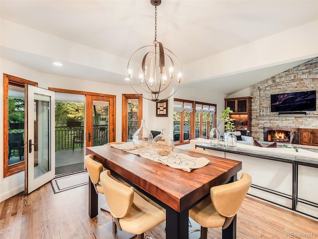 62 N Ranch Rd, Littleton, CO 80127 - dining room featuring french doors, light wood finished floors, a chandelier, plenty of natural light, and vaulted ceiling