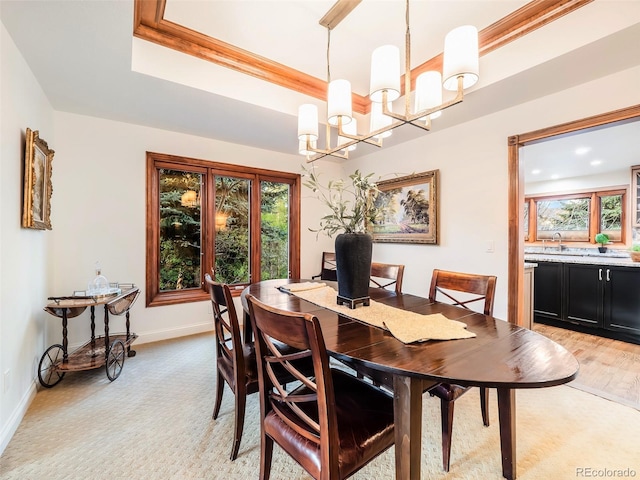 62 N Ranch Rd, Littleton, CO 80127 - dining room with a chandelier, baseboards, a raised ceiling, and light colored carpet