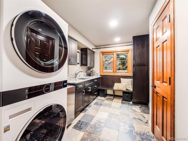 62 N Ranch Rd, Littleton, CO 80127 - laundry room with stacked washer and clothes dryer, cabinet space, and recessed lighting