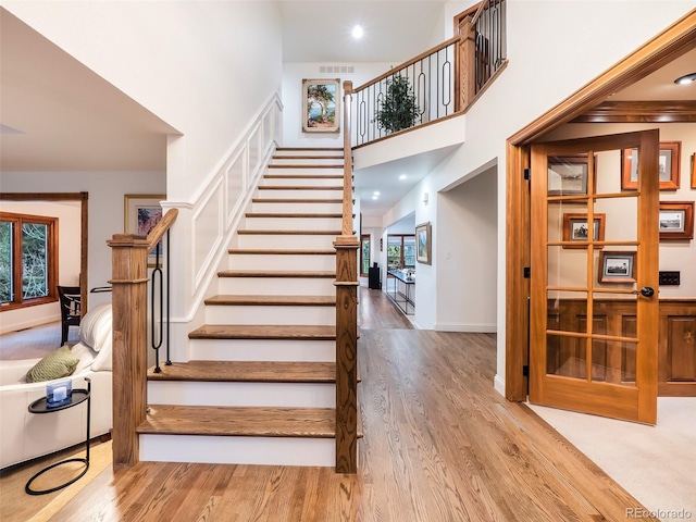 62 N Ranch Rd, Littleton, CO 80127 - stairway featuring wood finished floors, plenty of natural light, a high ceiling, baseboards, and recessed lighting