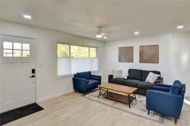 living room with light hardwood / wood-style floors and ceiling fan