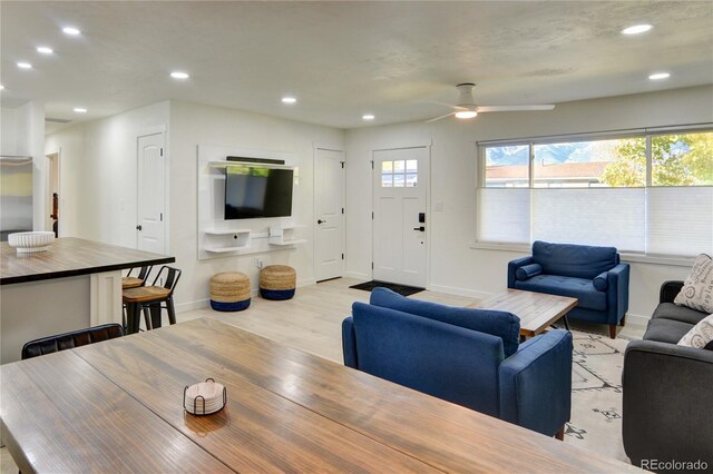 living room featuring light wood-type flooring and ceiling fan