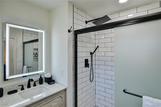 bathroom featuring an enclosed shower and vanity