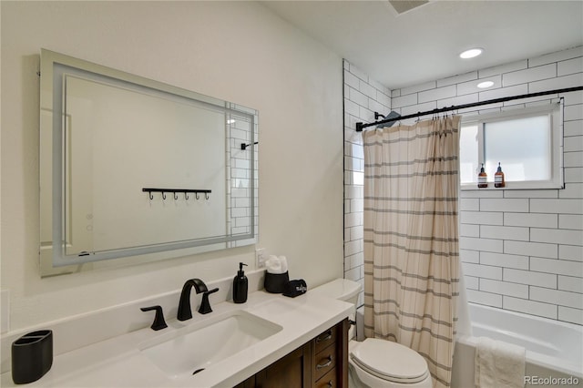 full bathroom featuring shower / tub combo, toilet, and vanity