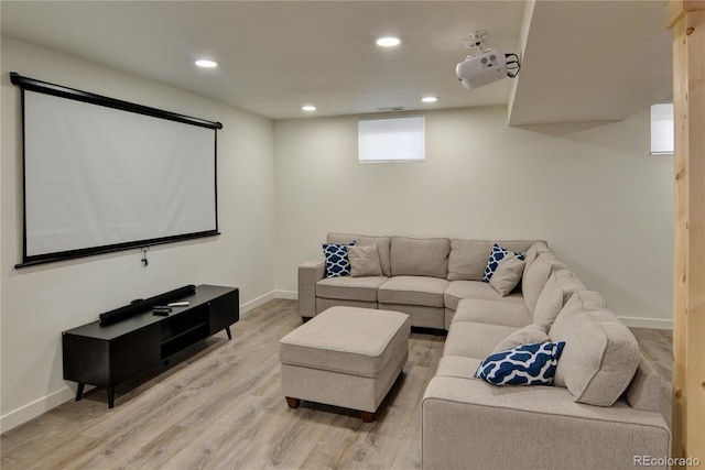 cinema room with light hardwood / wood-style floors