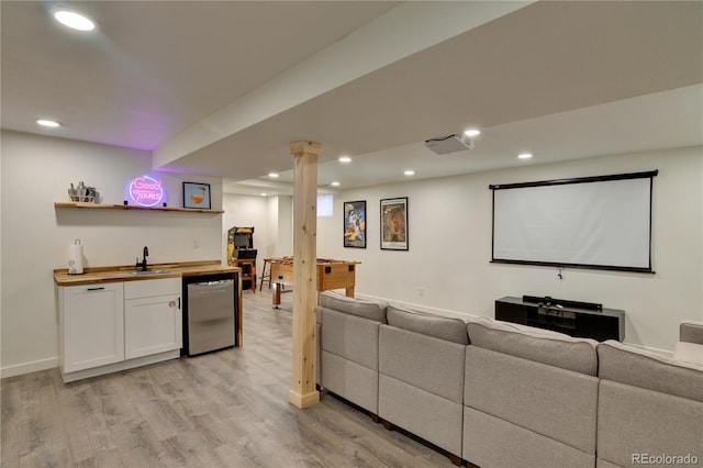 interior space with light wood-type flooring and indoor wet bar