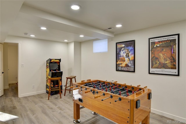 rec room with light hardwood / wood-style flooring