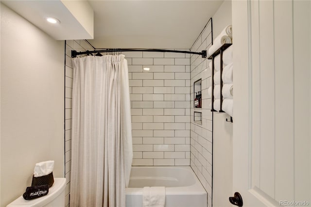 bathroom featuring toilet and shower / bathtub combination with curtain