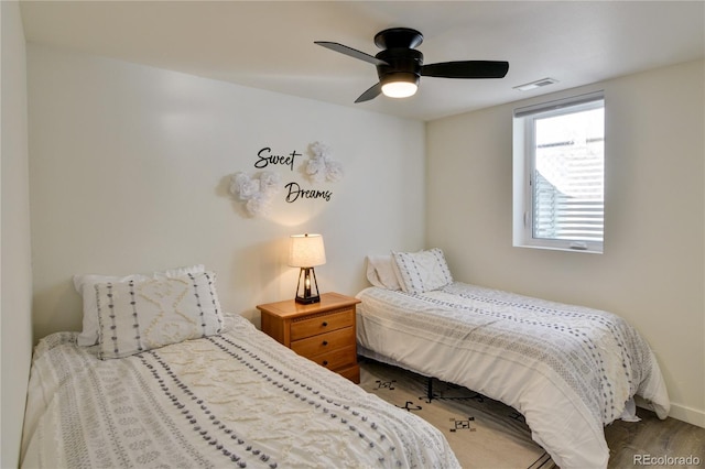 bedroom with ceiling fan and hardwood / wood-style floors