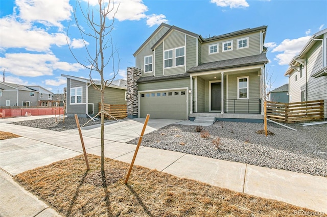 view of front of house featuring concrete driveway, a residential view, an attached garage, fence, and a porch