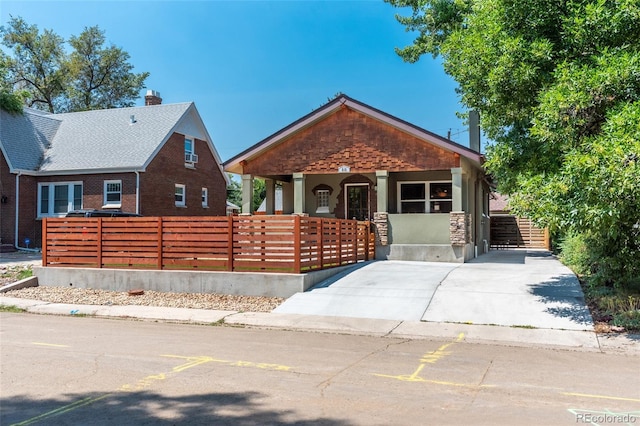 915 N Kearney St, Denver, CO 80220 - view of front facade featuring covered porch, a chimney, and fence